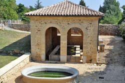 La Brugui&egrave;re covered lavoir across from