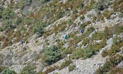 Three hikers trudging up the exposed