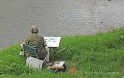 A landscape painter on the bank