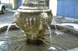 Ancient stone fountain on Place de