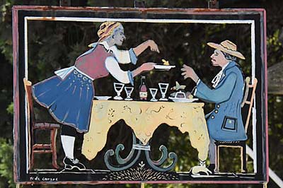 An elaborate hanging iron sign for